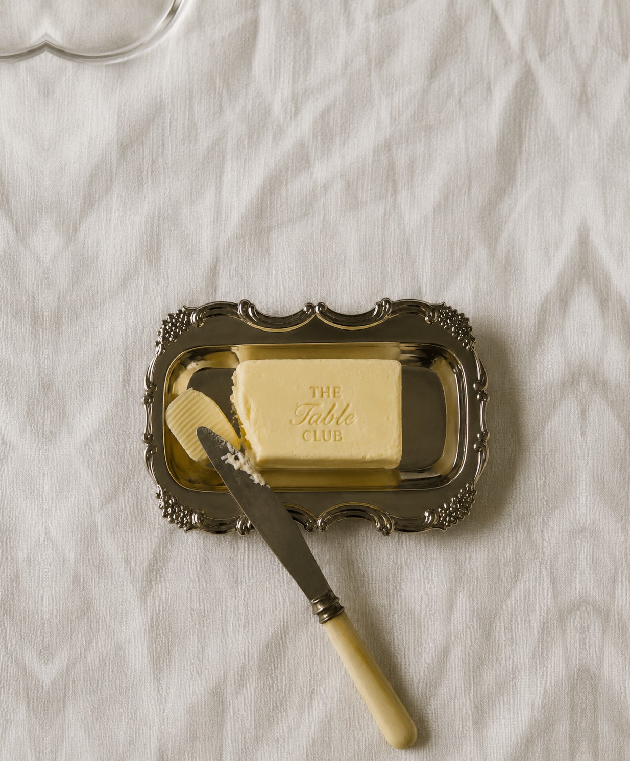 The Table Club butter, embossed and plated on a silver tray